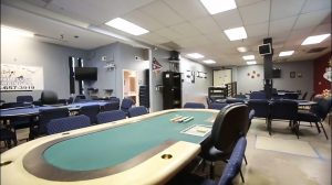 view inside the PPA building, the room mostly contains conference tables surrounded by chairs, with a few TV screens on the walls. it is an ugly and cold-feeling room.
