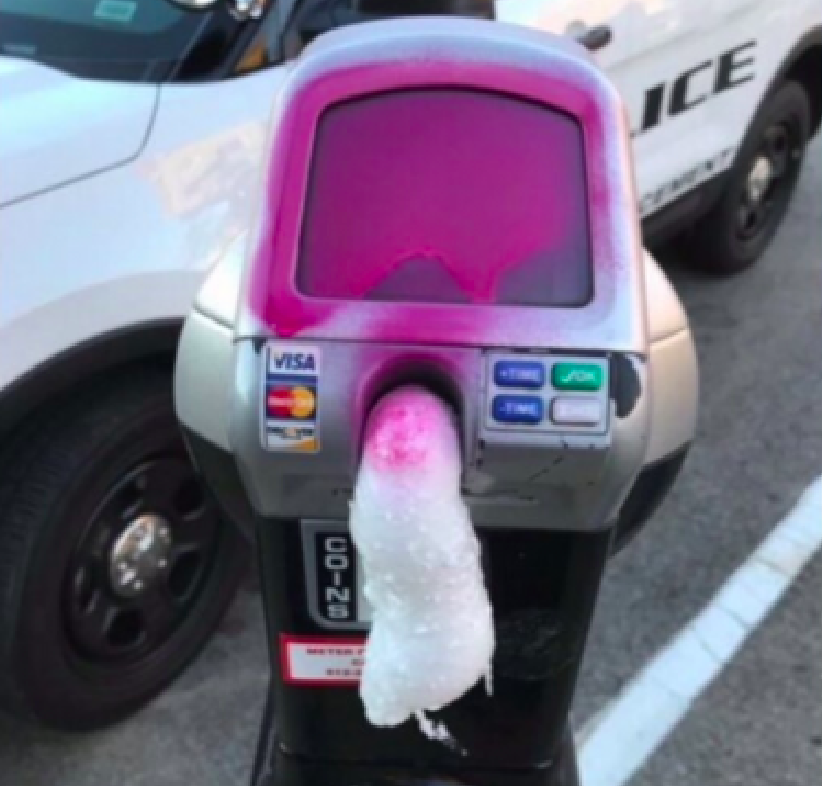 parking meter covered in spray paint and filled with expanding foam