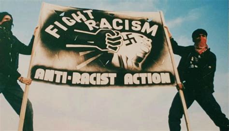 Anti-Racist Action banner with a fist punching a face that has a swastika on it. Banner reads: fight racism, anti-racist action